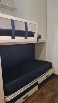 a bunk bed with a blue cushion on a shelf at Marina Mondello House comfort in Mondello