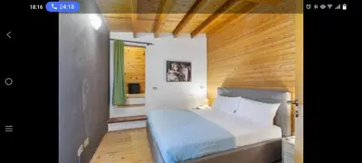 a bedroom with a large bed with a wooden ceiling at Palermo sweet house in Palermo