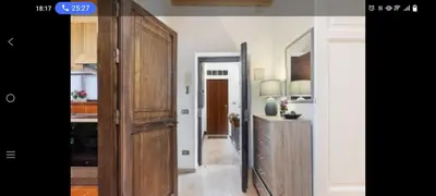 a kitchen with a large wooden cabinet in a room at Palermo sweet house in Palermo