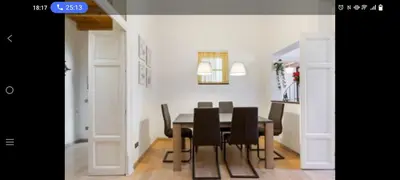a dining room with a table and black chairs at Palermo sweet house in Palermo