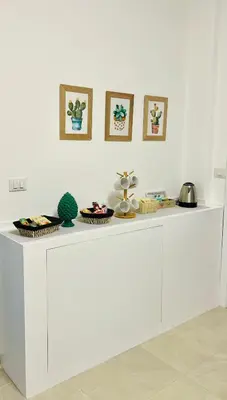 a white counter with three baskets on top of it at La Casa di Elisa Mini Apartment - Palermo in Palermo