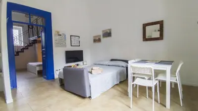 a bedroom with a bed and a table and a table and chairs at Cappuccini 145 R&P -Parcheggio gratis-Centro Storico-Cattedrale in Palermo