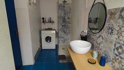 a bathroom with a sink and a washing machine at Cappuccini 145 R&P -Parcheggio gratis-Centro Storico-Cattedrale in Palermo