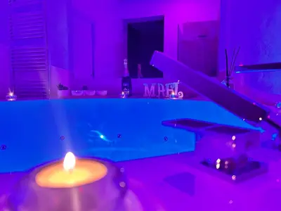 a bathroom with a lit candle in a purple room at Mael Superior Room in Palermo