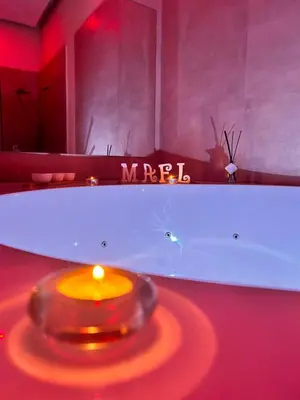a bath tub with a candle in front of a mirror at Mael Superior Room in Palermo