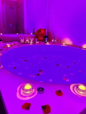 a purple room with two plates and candles on a table at Mael Superior Room in Palermo