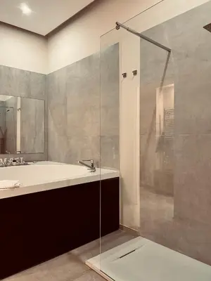 a bathroom with a tub and a sink and a shower at Mael Superior Room in Palermo