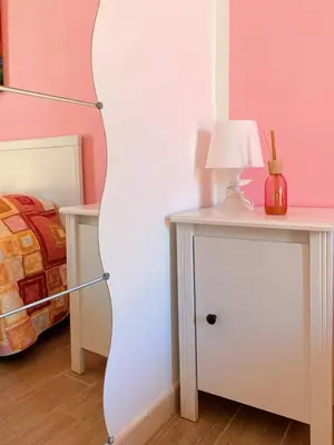 a room with a bed and a table with a lamp at B&B Pelagos in Castellammare del Golfo