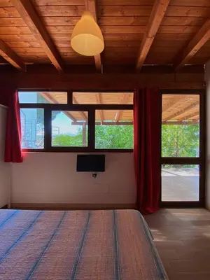a bedroom with a bed and a flat screen tv at B&B Pelagos in Castellammare del Golfo