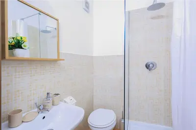 a bathroom with a sink and a toilet and a shower at Casa Querencia rooms in Palermo