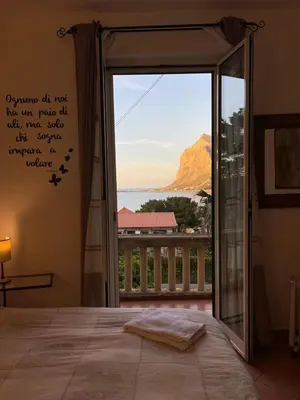 a bedroom with a window with a view of the ocean at FINESTRA SUL MARE in Palermo