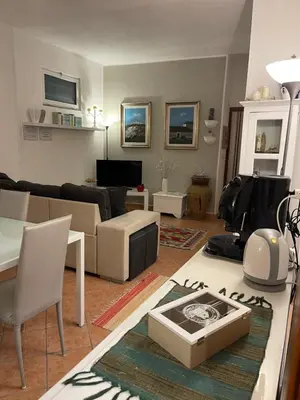 a living room with a couch and a table at FINESTRA SUL MARE in Palermo
