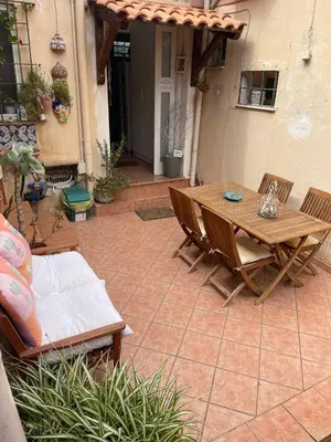 a patio with a wooden table and chairs at FINESTRA SUL MARE in Palermo