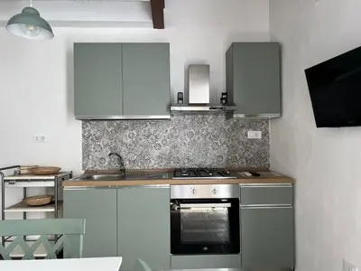 a kitchen with a stove and a sink at M'AMA apartment in Ficarazzi
