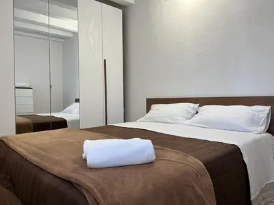 a bedroom with two beds with white pillows on it at M'AMA apartment in Ficarazzi