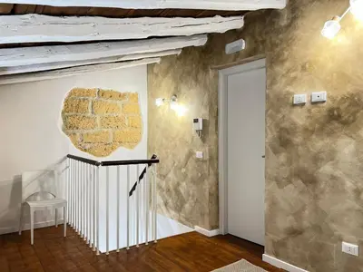 a room with a brick wall and a stair case at M'AMA apartment in Ficarazzi