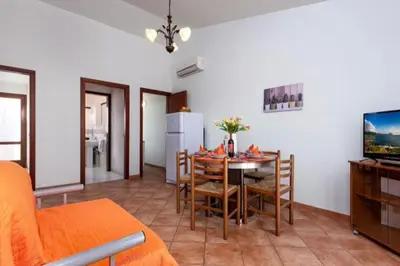a living room with a table and a dining room at Marconi in San Vito lo Capo