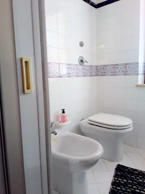 a white bathroom with a toilet and a sink at Marconi in San Vito lo Capo