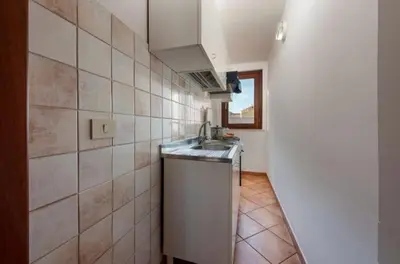 a small kitchen with a sink and a window at Marconi in San Vito lo Capo