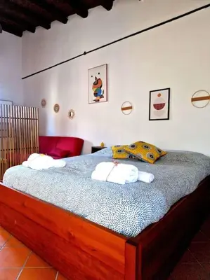 a bedroom with a bed with towels on it at Wood House - Palermo in Palermo