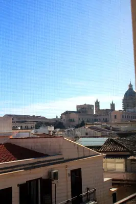 a view of a city with buildings and a blue sky at Wood House - Palermo in Palermo
