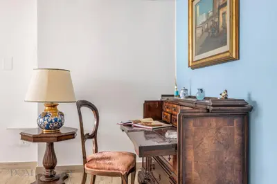 a desk with a lamp and a chair in a room at La Dimora del Mare by Domus Sicily in Mondello