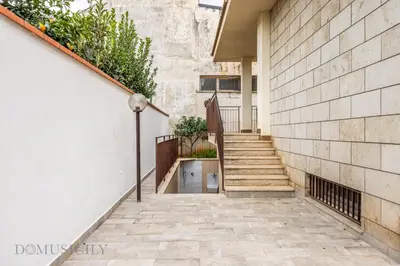 a stairway leading up to a building with a stone wall at La Dimora del Mare by Domus Sicily in Mondello