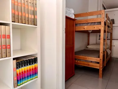 a room with a bunk bed and books at Flat with Terrace & Pool in Mondello