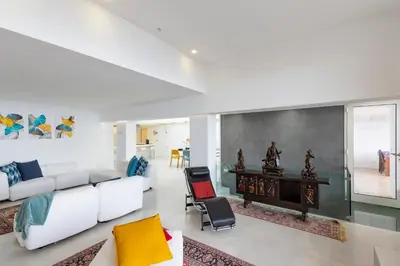 a living room with a couch and a table at Addaura Home in Palermo
