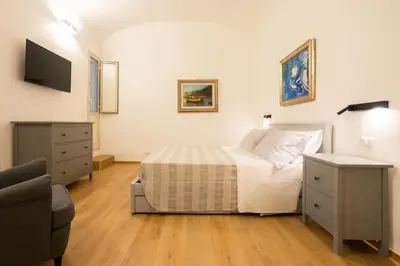 a bedroom with a bed and a television in it at Bibi house a San Giovanni degli Eremiti in Palermo