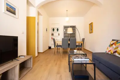 a living room with a couch and a table at Bibi house a San Giovanni degli Eremiti in Palermo