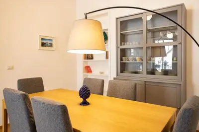 a dining room table with chairs and a lamp at Bibi house a San Giovanni degli Eremiti in Palermo