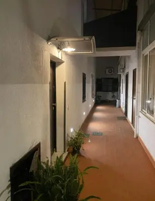 an empty hallway of a building with plants in it at Casa Swamy in Palermo