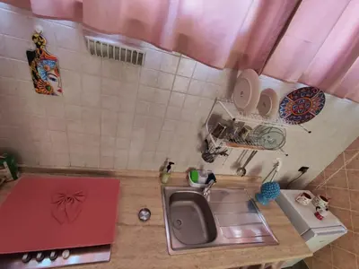 a small kitchen with a sink and a counter at Casa Swamy in Palermo