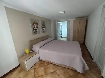 a bedroom with a large bed in a room at Montesanto Home in Palermo