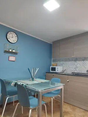 a kitchen and dining room with a table and chairs at Montesanto Home in Palermo