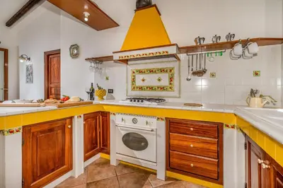 a kitchen with a white stove and a sink at Villa Miceli in Scopello