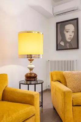 a lamp sitting on a table next to two chairs at 70 Lab Apartment in Palermo