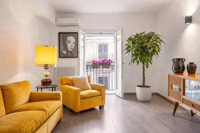 a living room with a yellow couch and a chair at 70 Lab Apartment in Palermo