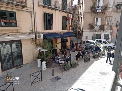 a group of people sitting in chairs on a city street at bb45 superior holiday's house CIR 19082053C204471 in Palermo