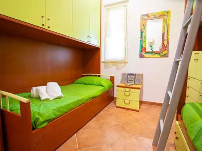 a bedroom with two bunk beds and a mirror at VILLA ANGELA TRABIA in Trabia