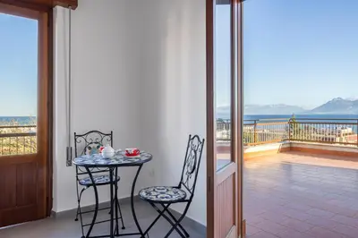 a table and two chairs on a balcony with a view at Kastemar in Porticello