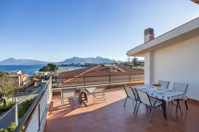 a patio with a table and chairs on a balcony at Kastemar in Porticello