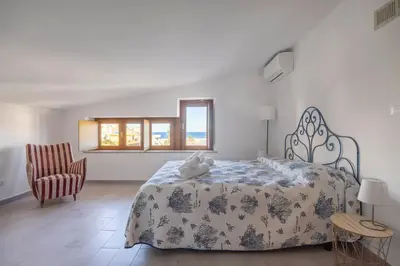 a bedroom with a bed with a teddy bear on it at Kastemar in Porticello