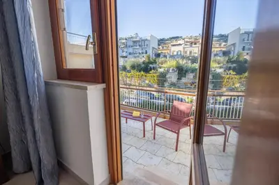 a view of a balcony with two chairs and a window at Kastemar in Porticello