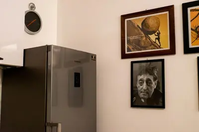 a refrigerator in a room with pictures on the wall at Le Case Di Romeo Alla Vucciria in Palermo