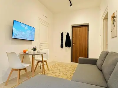 a living room with a couch and a table at Corte del Tribunale in Palermo
