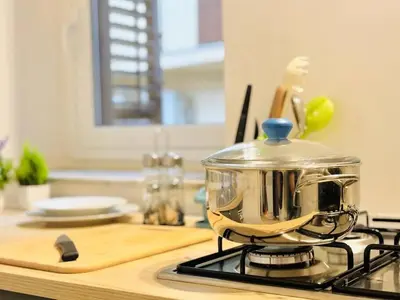 a pot sitting on top of a stove in a kitchen at Corte del Tribunale in Palermo