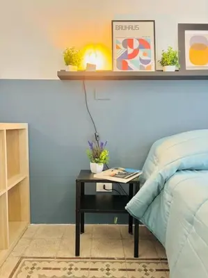 a bedroom with a bed and a table next to a bed at Corte del Tribunale in Palermo