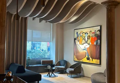 a living room with chairs and a painting on the wall at Palazzo Liberty Unique Hotel by Geocharme in Palermo
